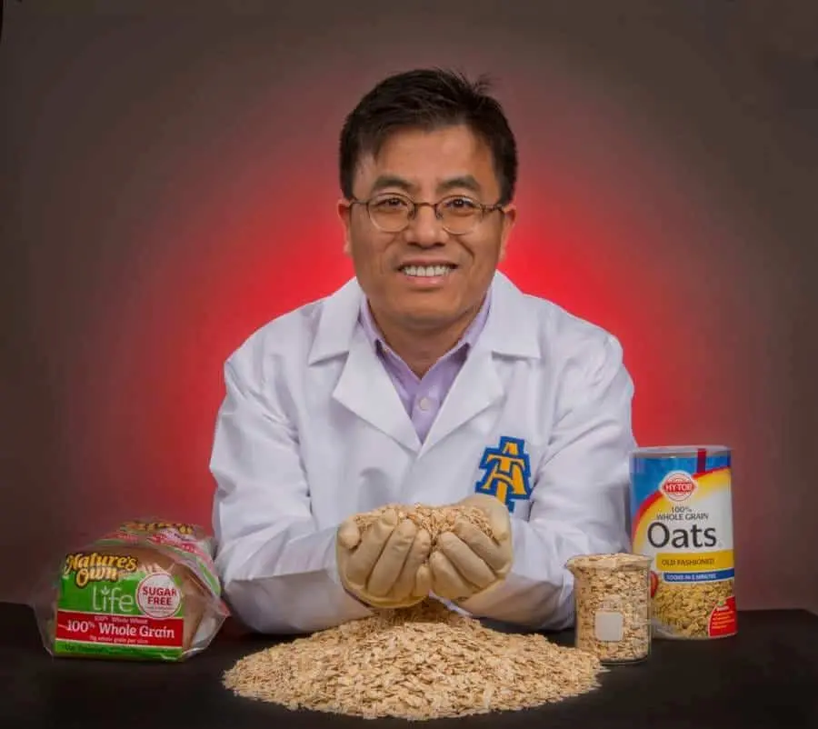 Organic whole grain oats with a scientist demonstrating the health benefits and nutritional value of.