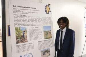Soil Conservationist Trainee presenting project poster at CAES News event.