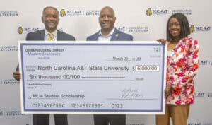 Large check presentation at North Carolina A&T State University for student scholarship award.