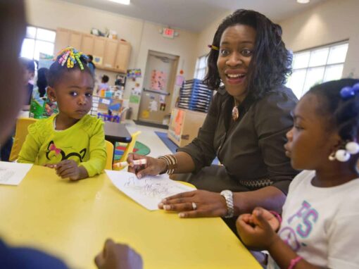Engaging teacher interacting with young children in a classroom setting for early childhood educatio.