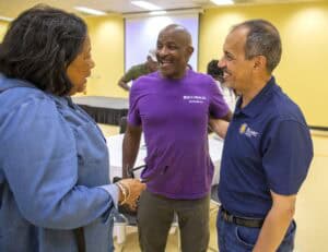 COVID-19 health professionals engaging in a friendly conversation at a healthcare facility.