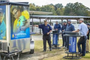 Agricultural education event with students and instructors outdoors.