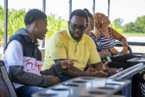 Accessible learning discussion with diverse group of students and instructor outdoors.