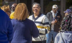 Celebrating community and diversity at CAES News event with smiling people outdoors.