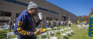 Enjoying outdoor event with food and crowd at CAES News.