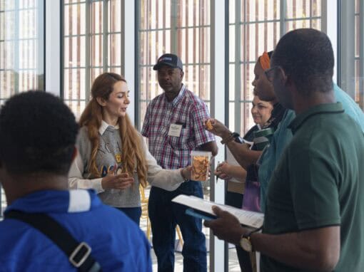 Diverse group of people engaging in a discussion at a conference or event.