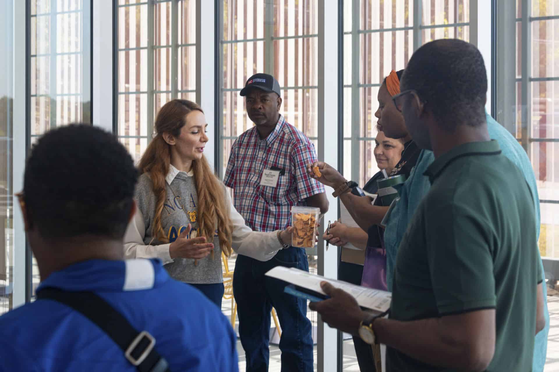 Diverse group of people engaging in a discussion at a conference or event.