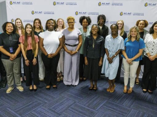 Group of diverse professionals standing together in a conference room.