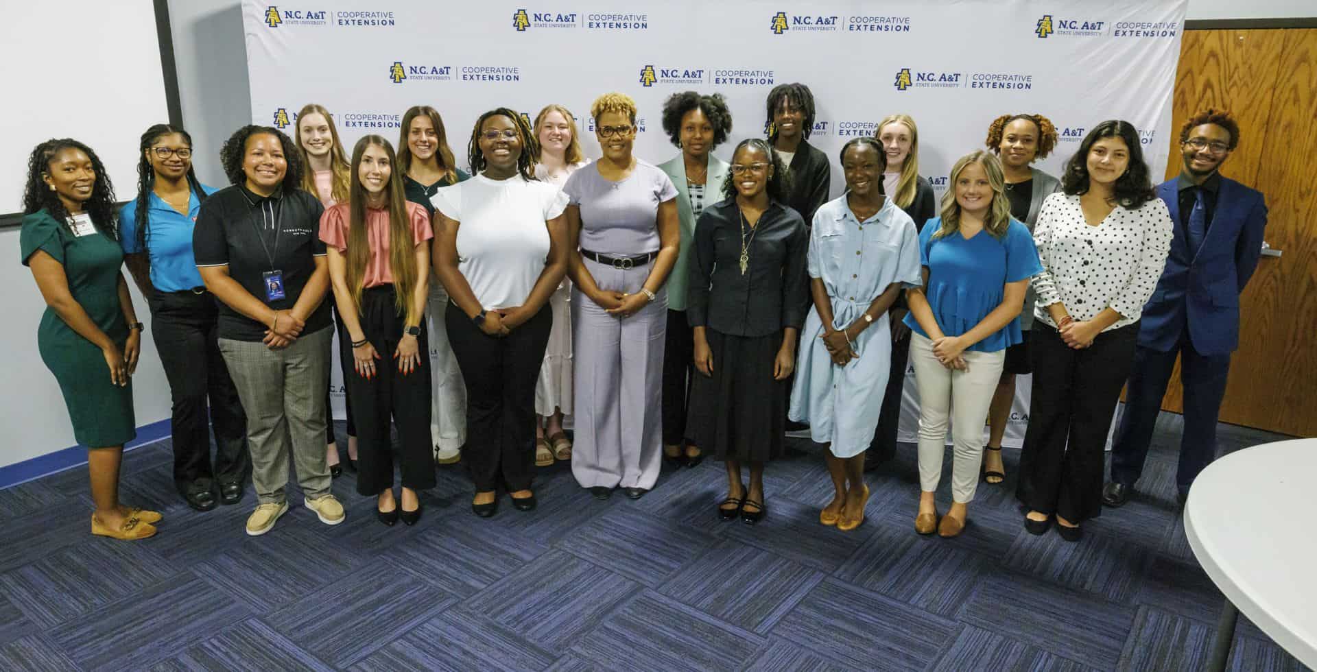 Group of diverse professionals standing together in a conference room.