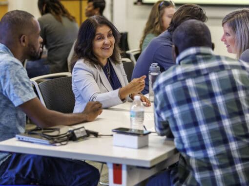 Diverse group of professionals in a business meeting or workshop setting.