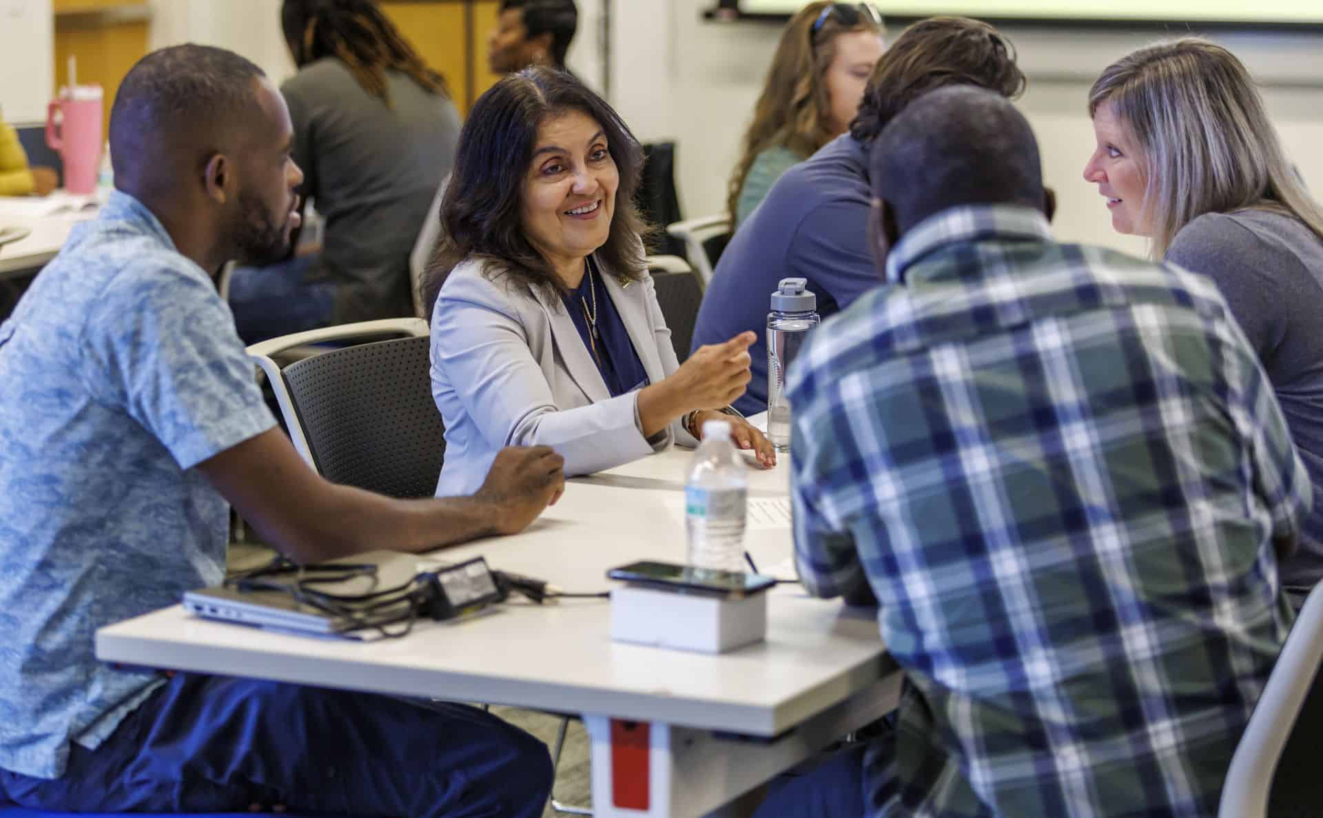 Diverse group of professionals in a business meeting or workshop setting.