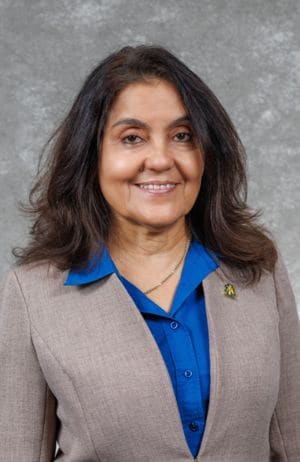 Professional woman in business attire smiling for a portrait.