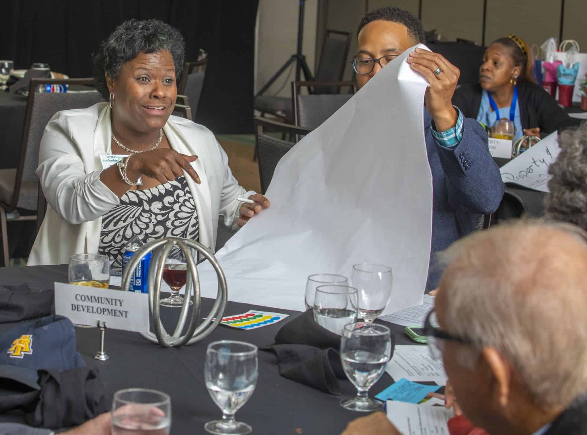 Community leaders at a development meeting discussing plans and strategies.